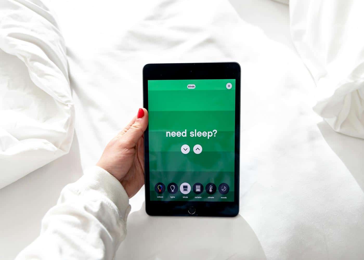 Best sleep hygiene app - woman holding a tablet showing a sleep app