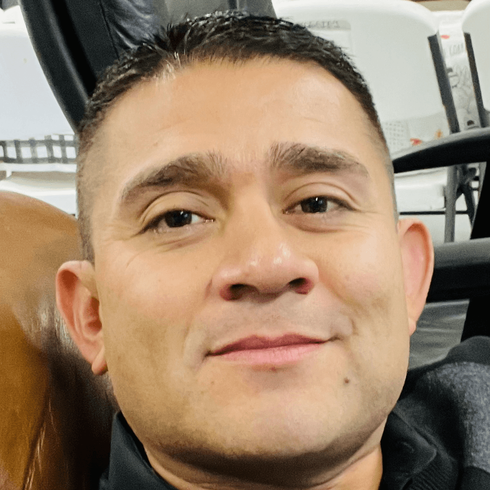 a man with a goatee smiles at the camera