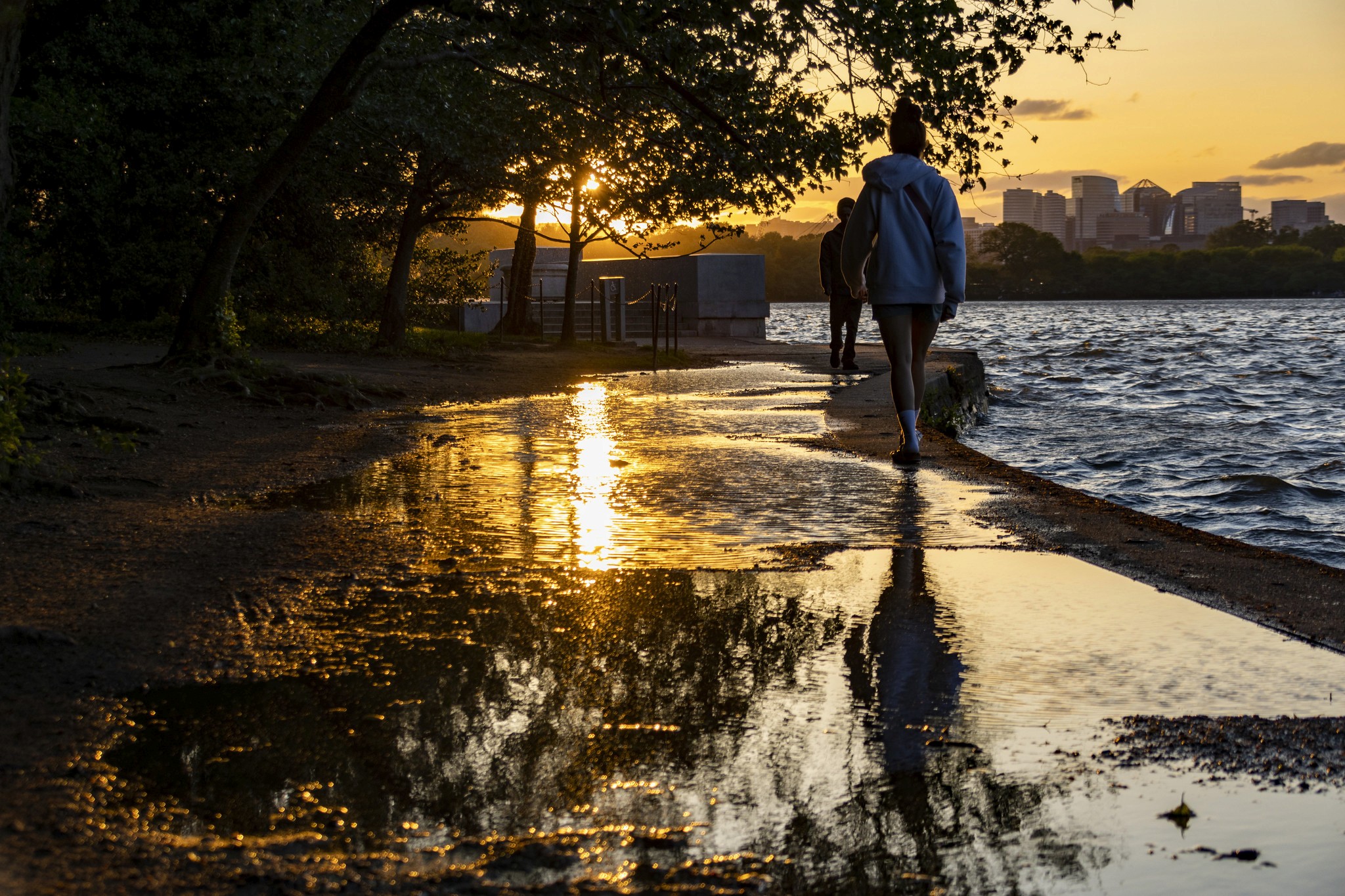 People strolling along the potomac river in the evening.