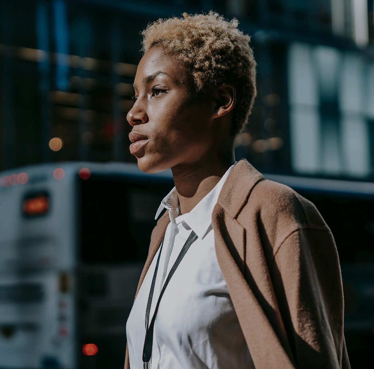 The side-view of a younger woman in the street