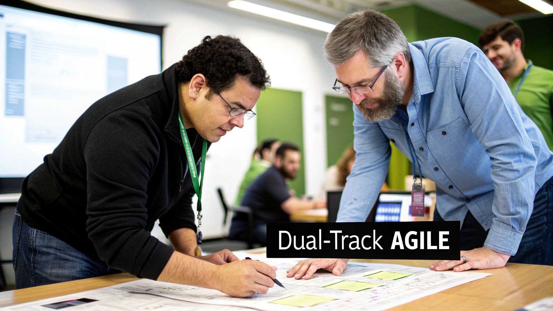 Two men wearing glasses collaborate over documents and sticky notes on a table in a bright office.