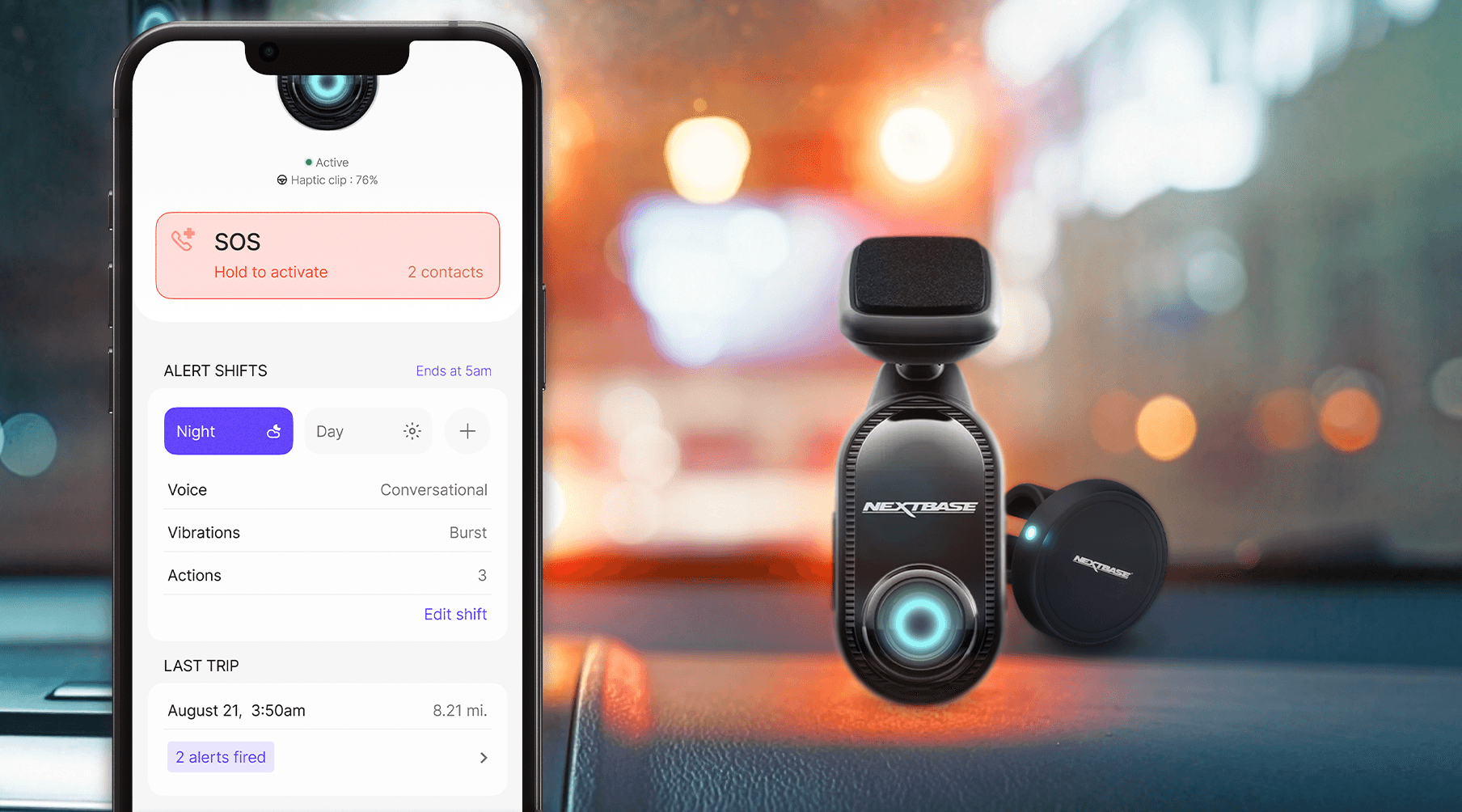 Phone showing Nextbase app with SOS and alerts, dashcam and haptic clip on the car dashboard behind it.