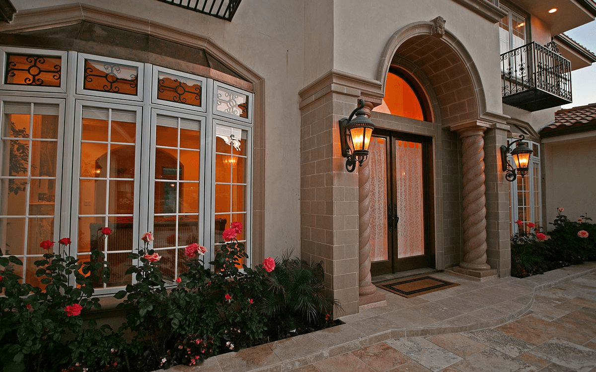 Exterior facade details showcasing the Mediterranean design elements, highlighting the home's craftsmanship and style.