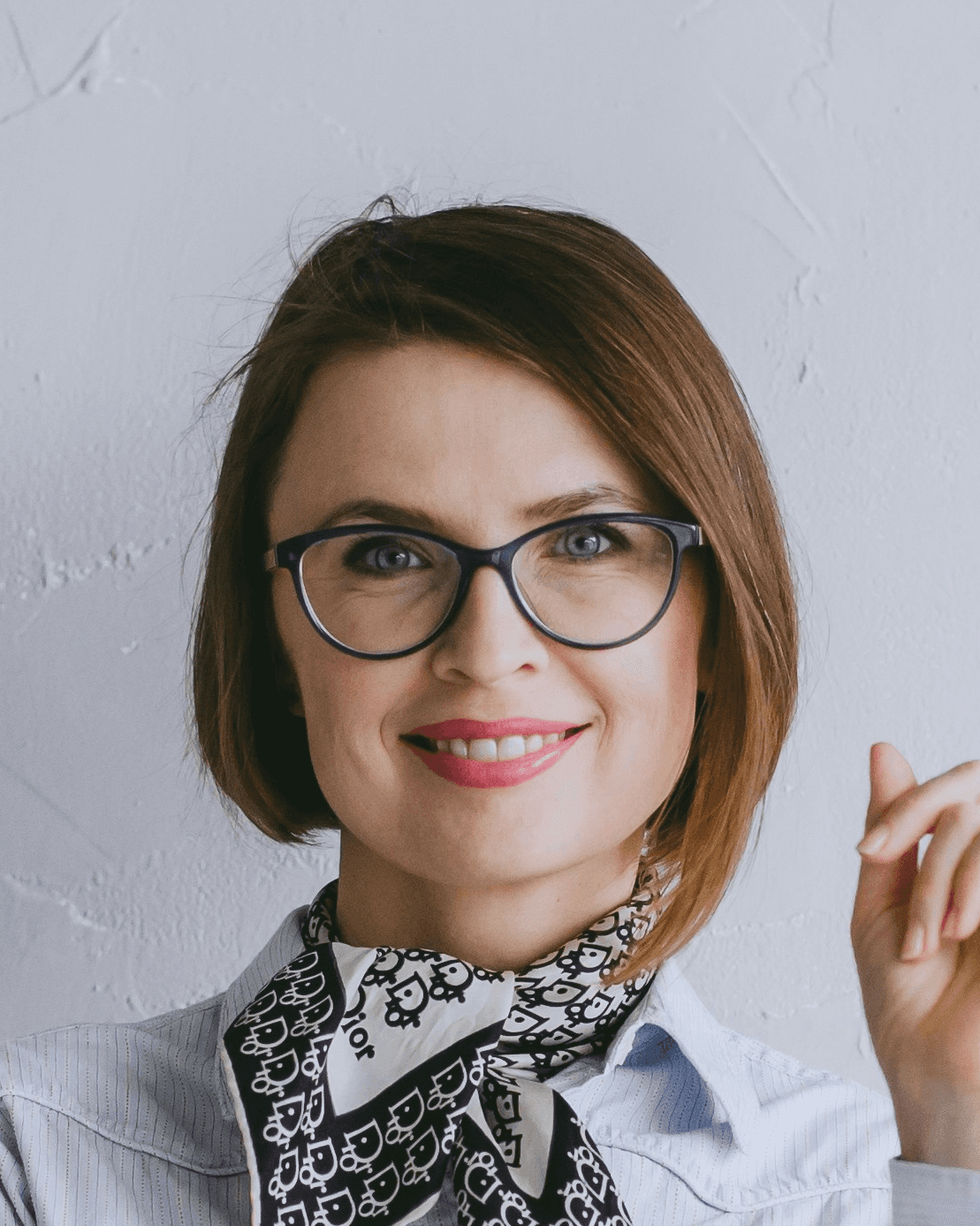 a woman wearing glasses and a bow tie