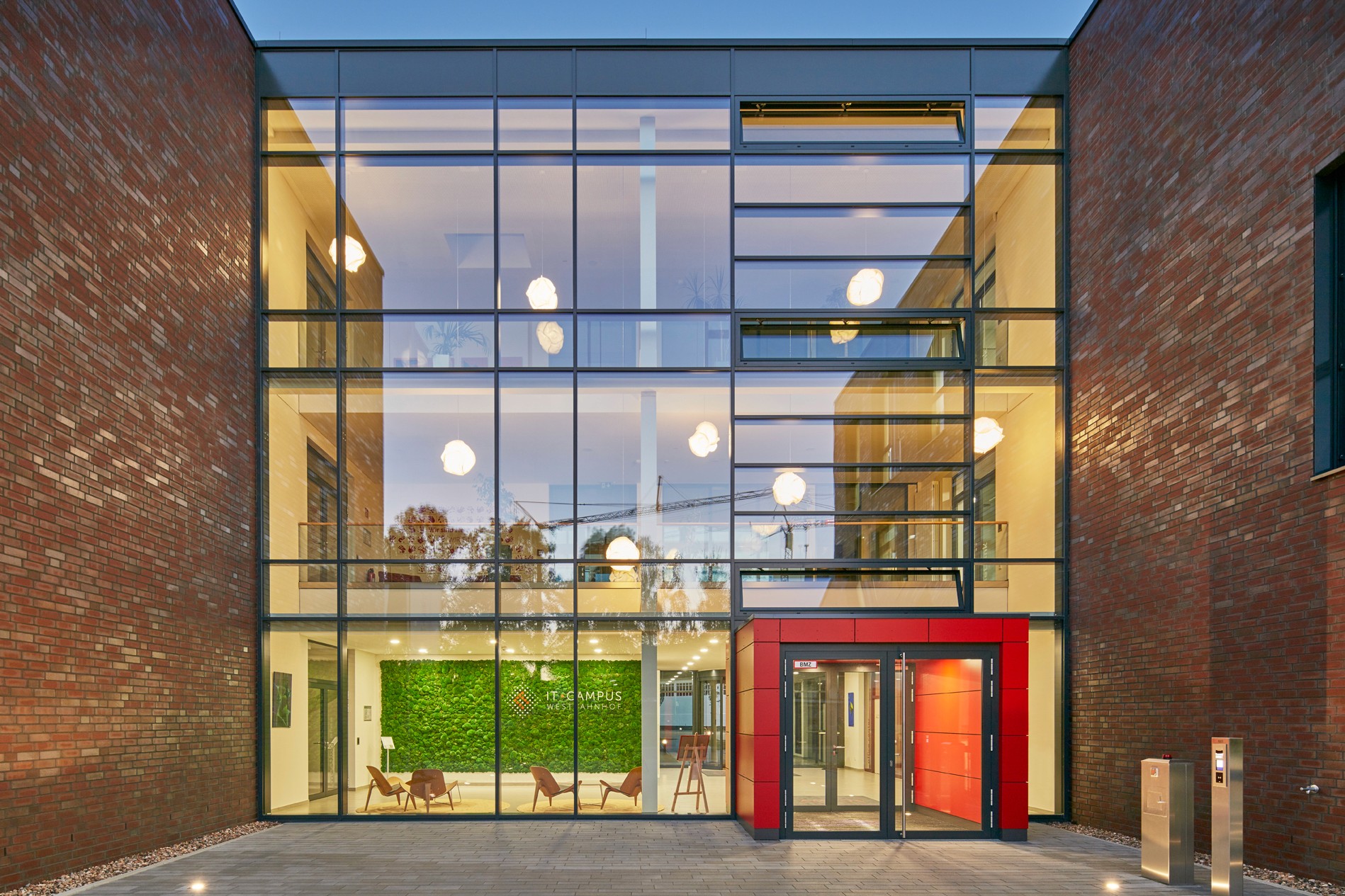 two people in a workspace working on their laptops 