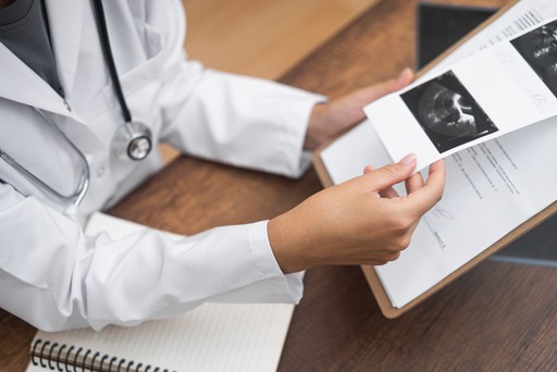 Neurologist doctor reviewing patient's reports and results during consultation