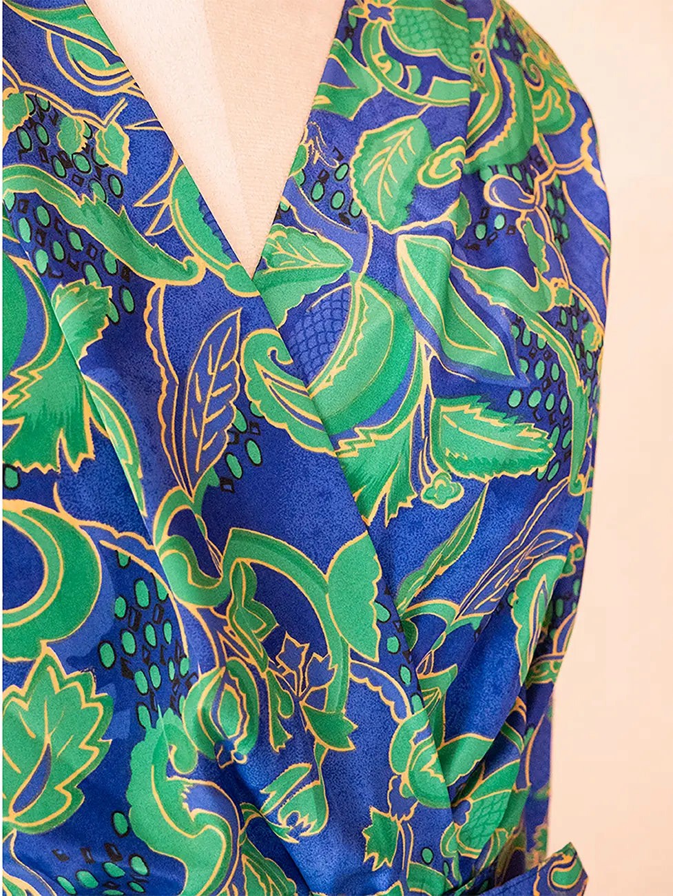 Vintage green and blue paisley print two-piece set with structured top and pencil skirt.
