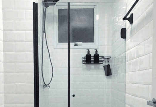 man wearing gray polo shirt beside dry-erase board