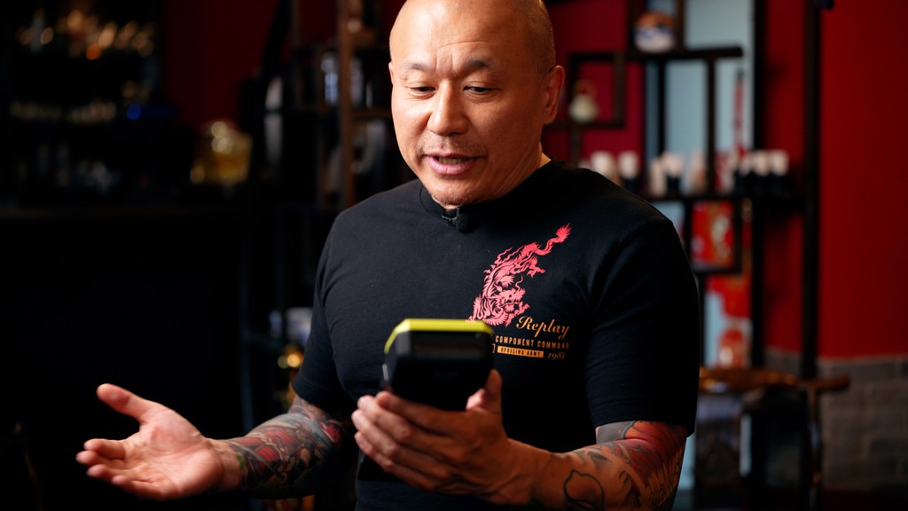 man holding card machine