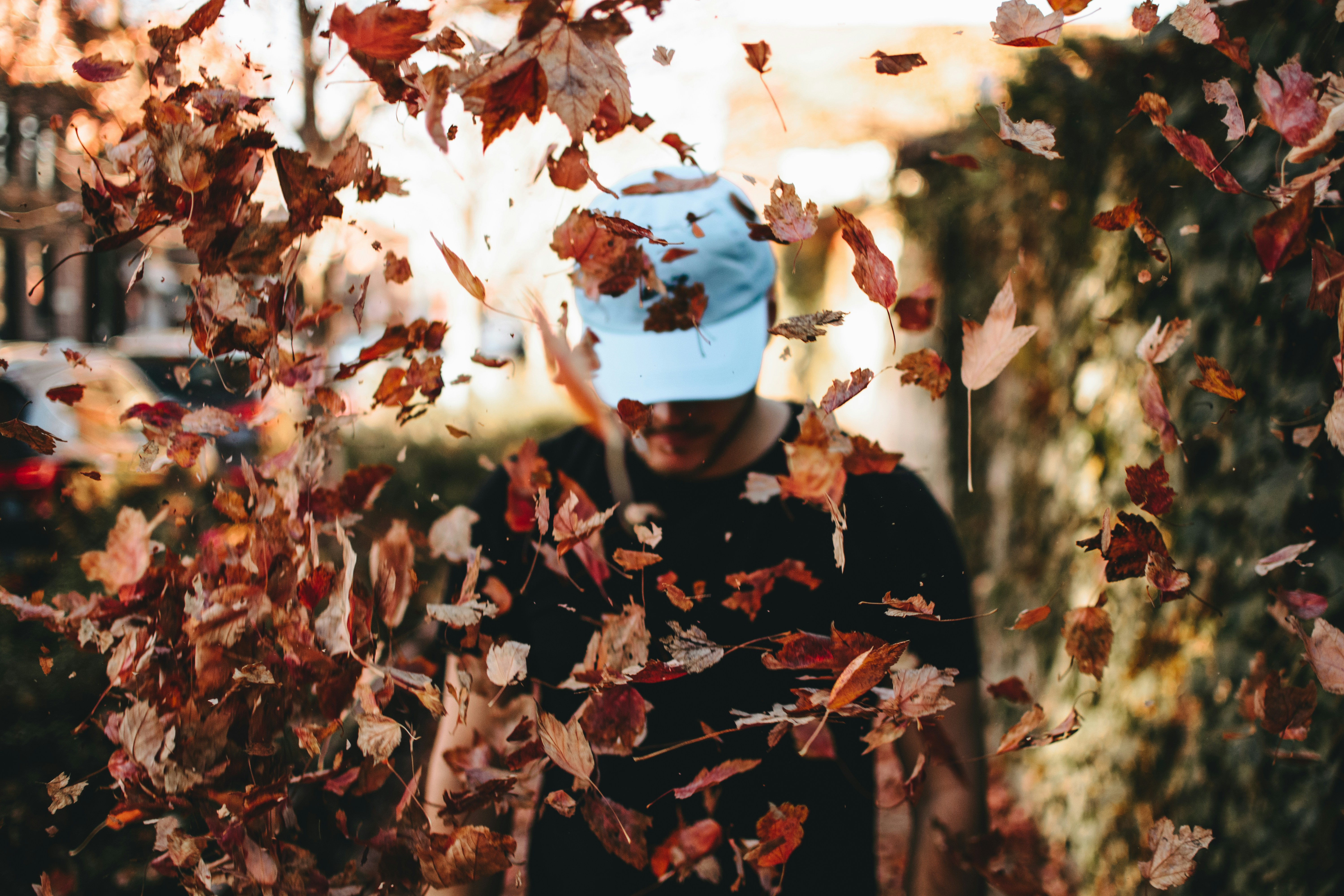 man in autumn leaves - Colors For Autumn Skin Tone