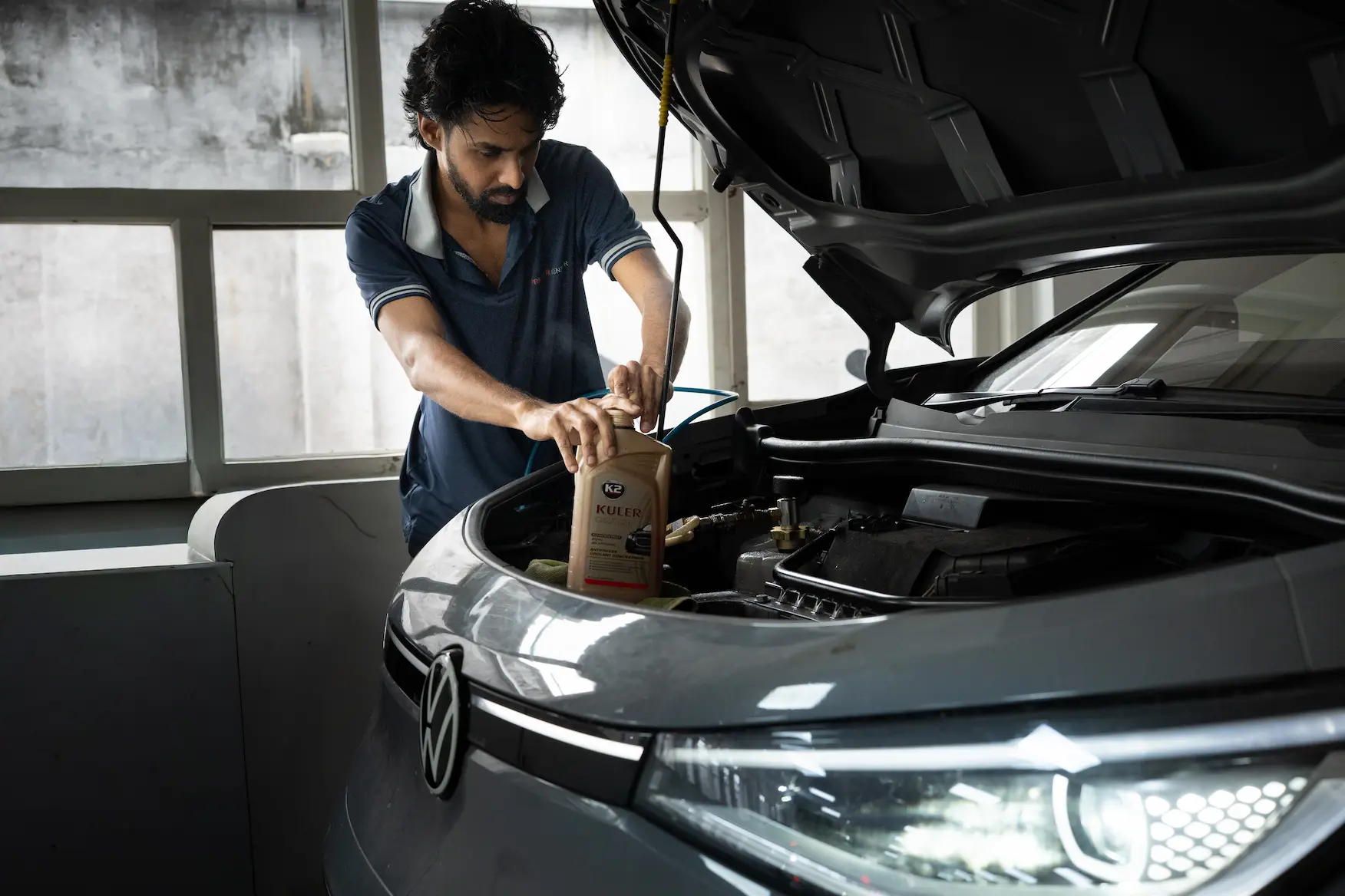 Checking engine oil of a car at Ideal