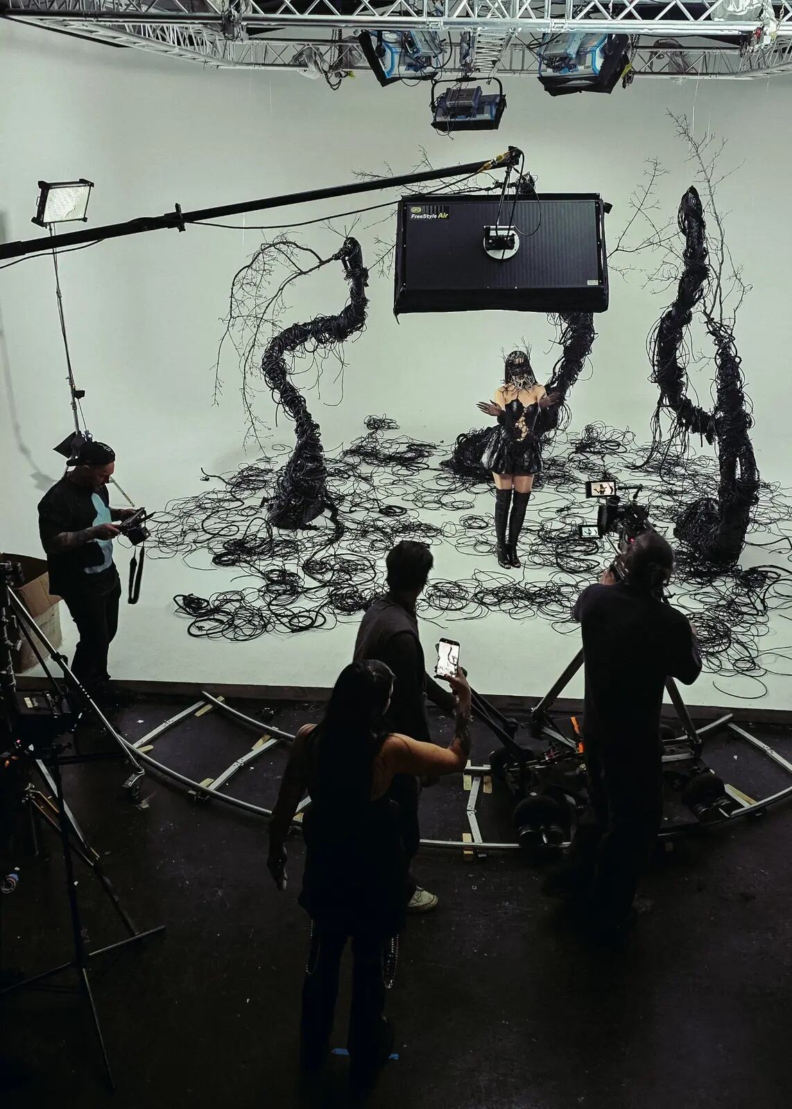 Music video production crew working around a custom studio set