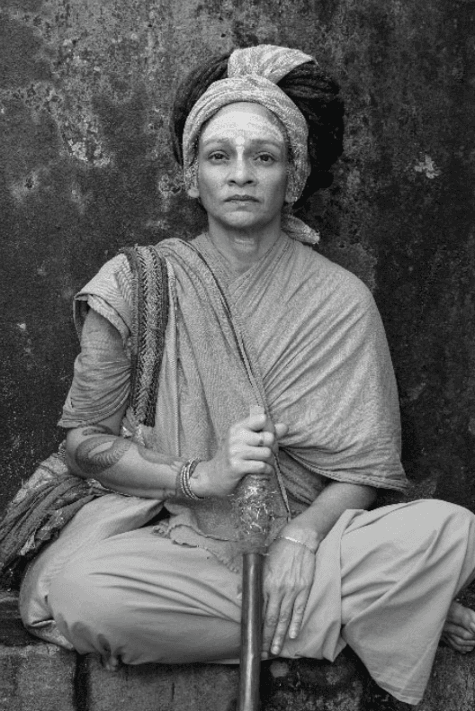 a group of women standing on top of a sandy beach