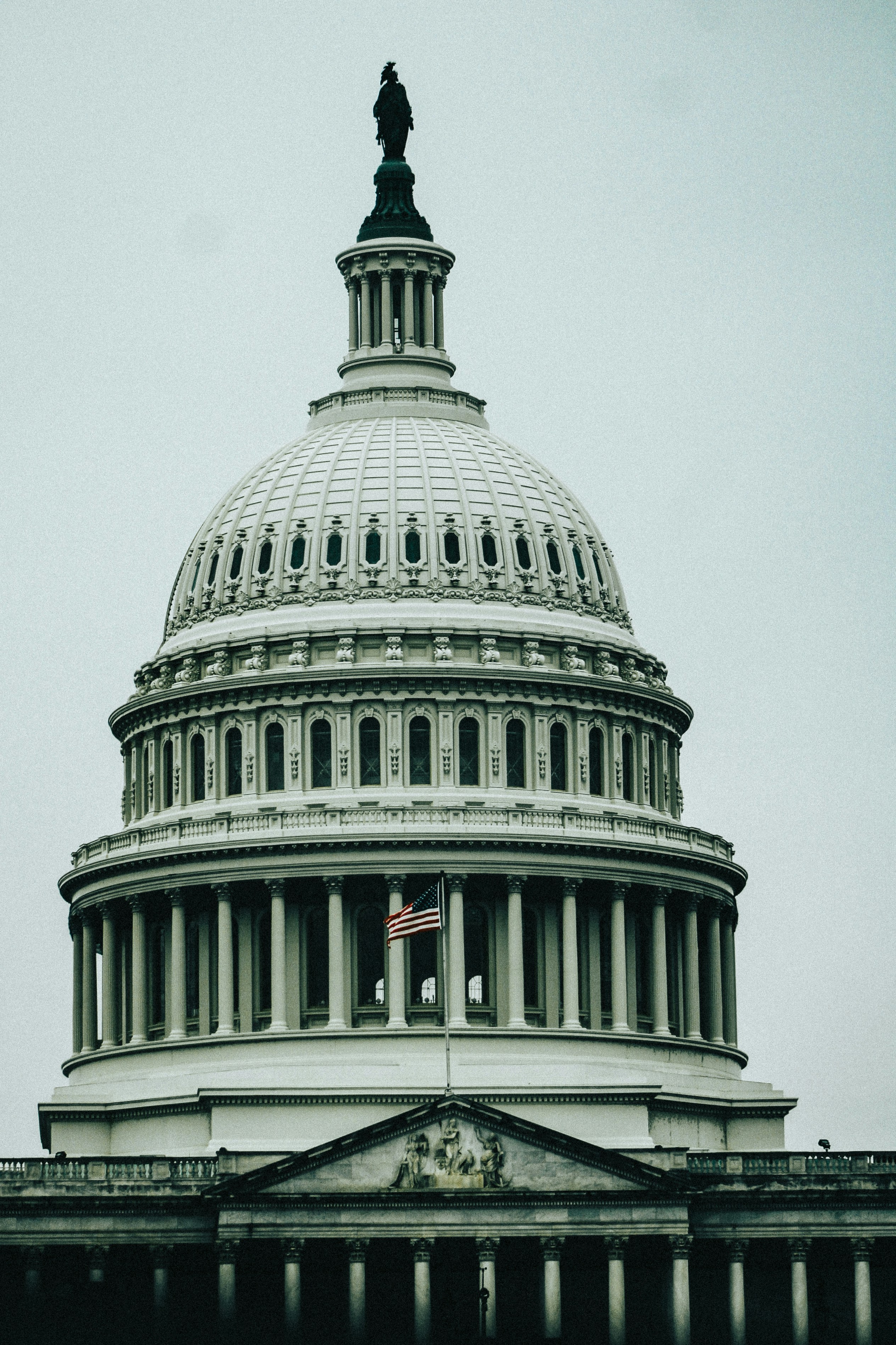 The united states capitol building dome against a cloudy sky.