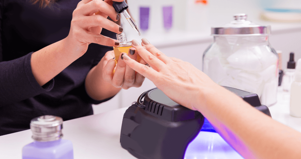 Nail technician applying polish, representing cost-effective bookkeeping for nail salons