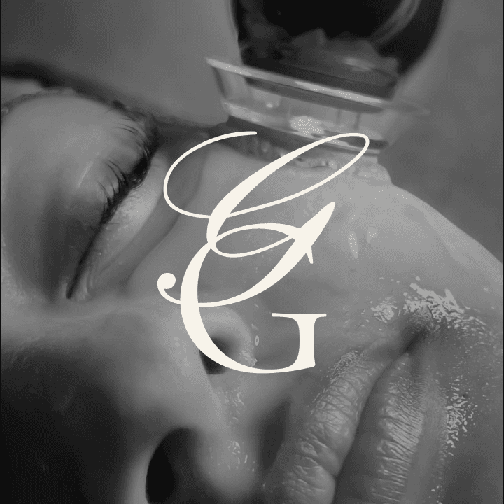 A woman lying down in a spa setting, relaxing with her eyes closed. Sunlight streams through blinds, casting striped shadows on her face. The scene conveys a sense of serenity and well-being.