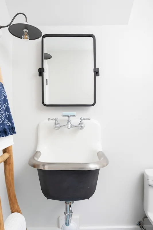 Quaint powder room with ladder towel rack and pedestal sink in North Tustin Remodel & Addition. Photo by Todd Huge.