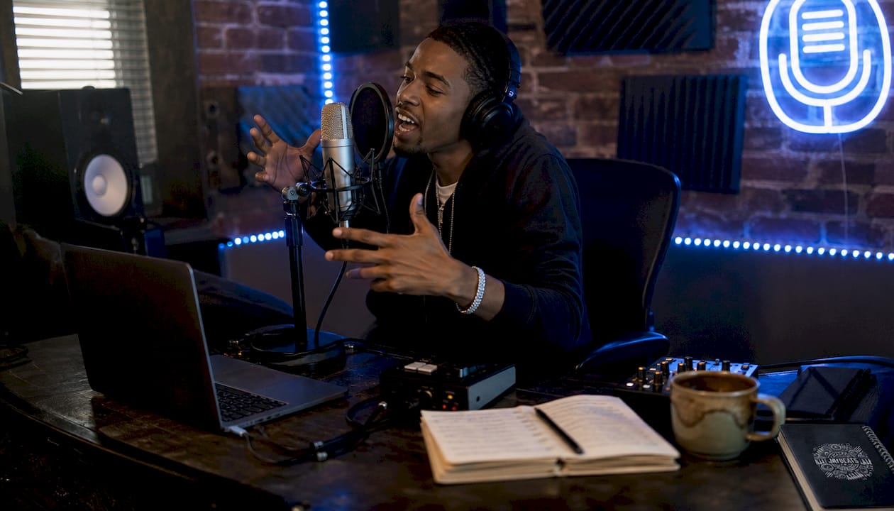 Rapper recording vocals in home studio