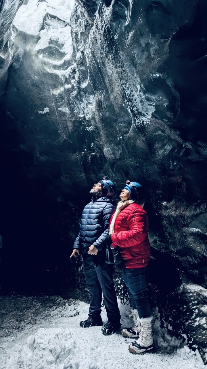 person standing in ice cave at daytime