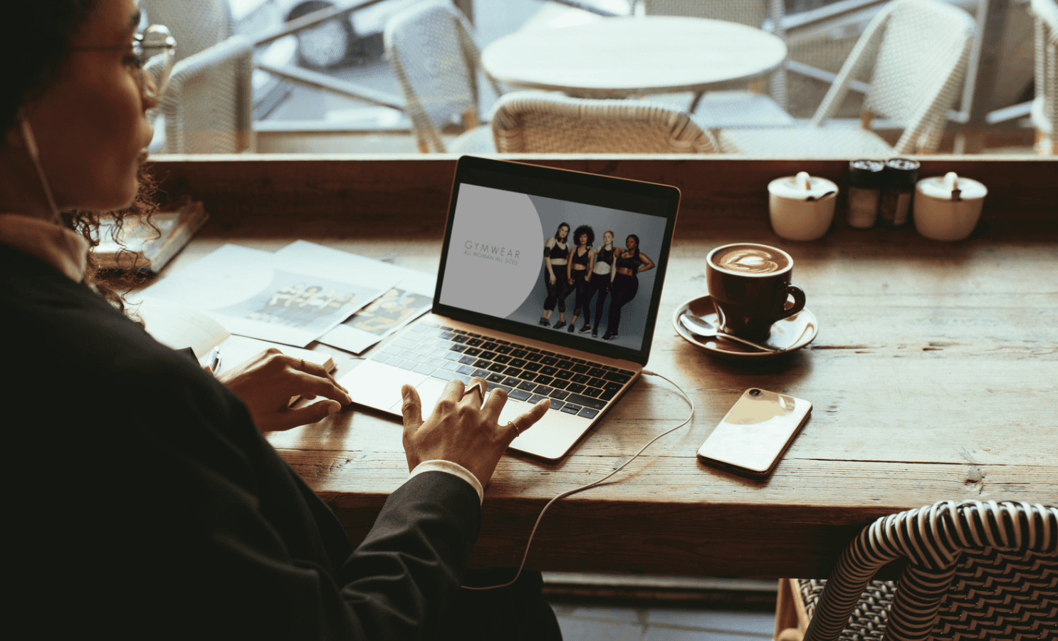 Professional reviewing data on a laptop in a café setting, symbolizing aligning Amazon PPC goals with inventory, margins, and seasonal demand.