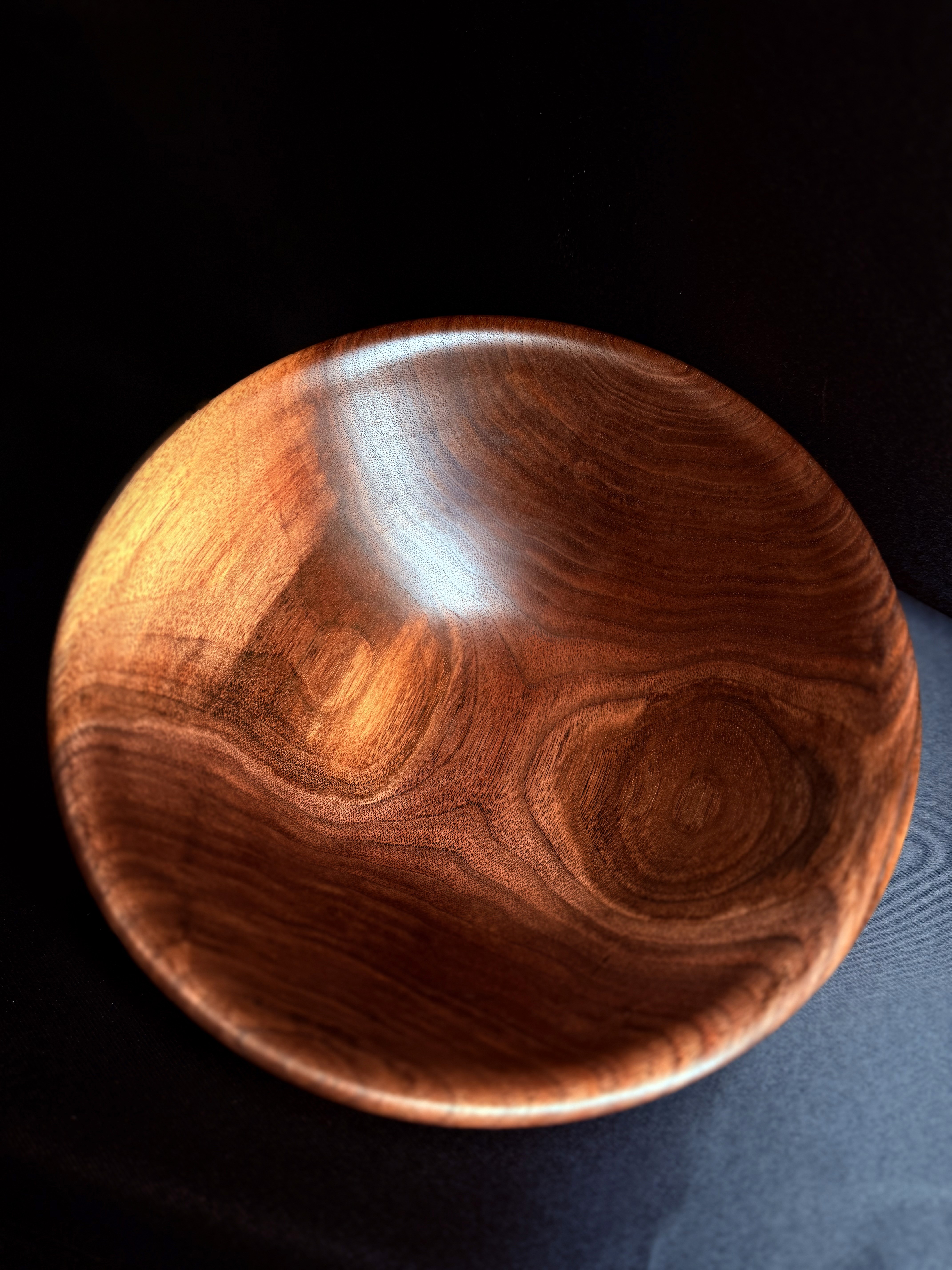 Supporting view of the Bullseye Walnut Bowl, showing its circular grain pattern.