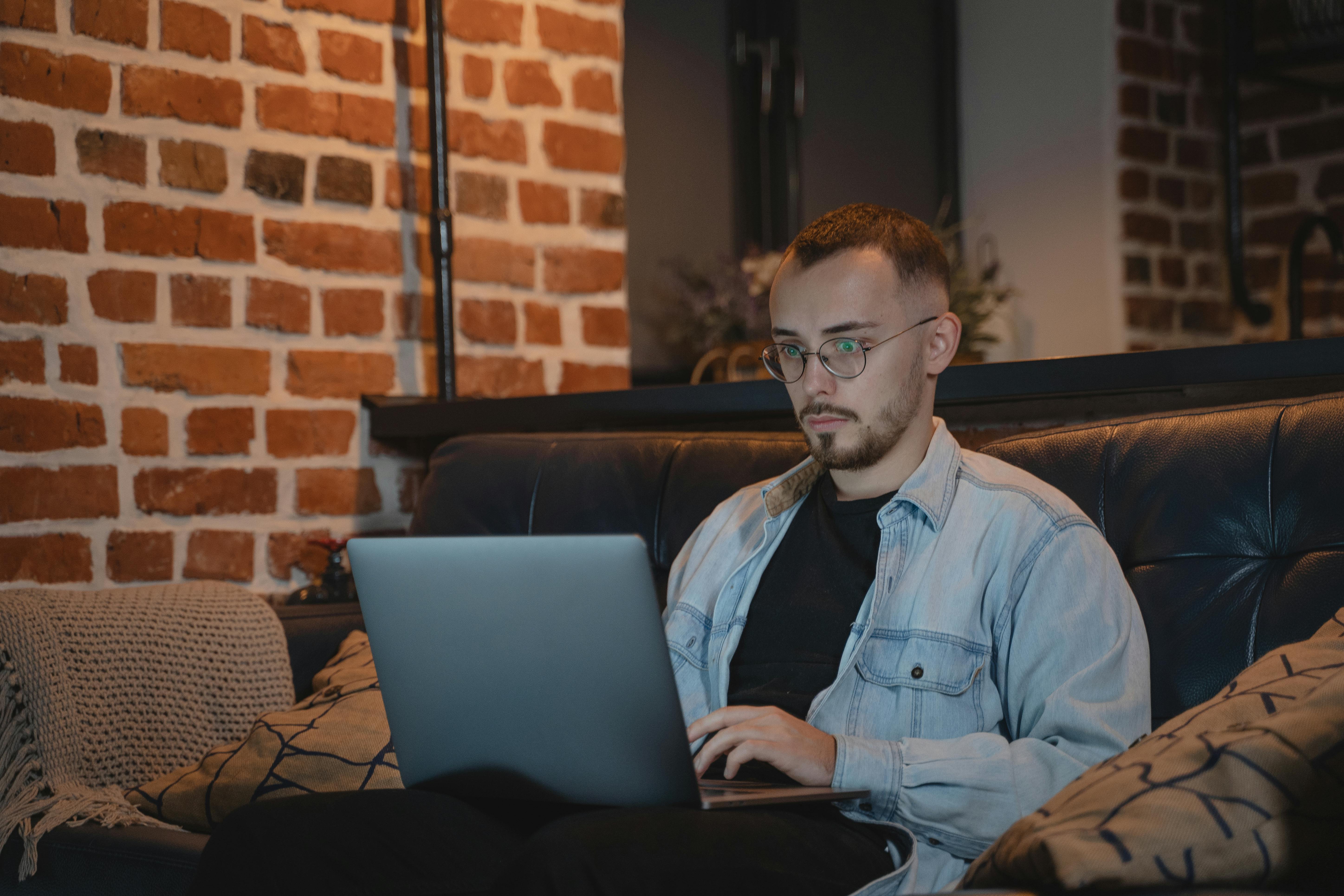 Man sending bulk emails using laptop