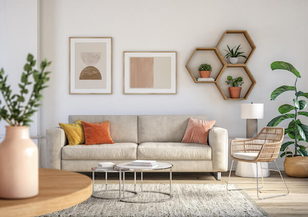 minimalist living room with beige couch surrounded by plants and neutral decor