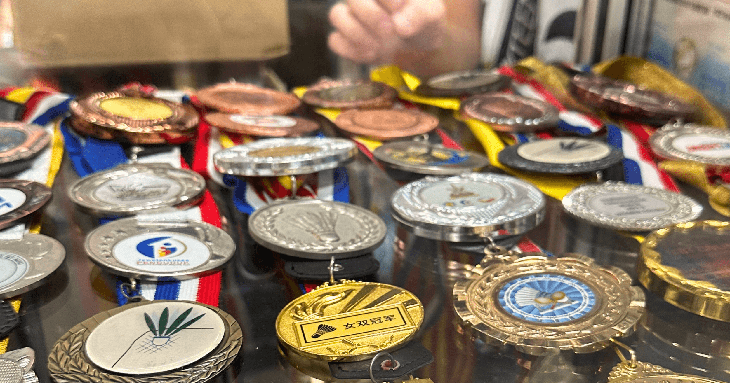 Badminton championship medals displayed at a retail store