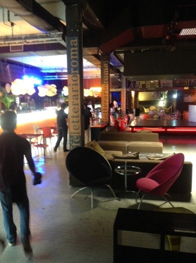 lounge room with three people, chairs and bar