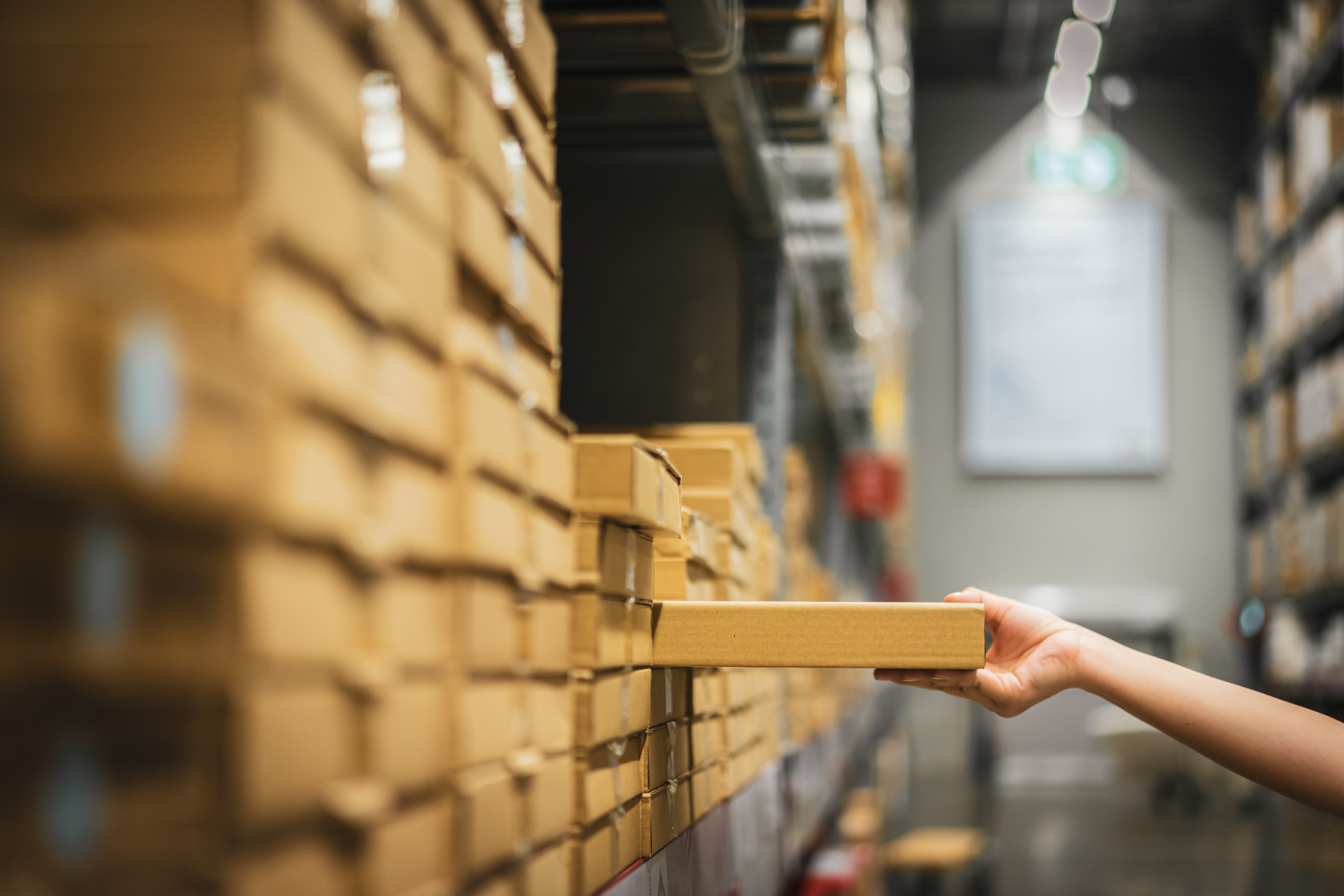 An employee collects a package from a warehouse