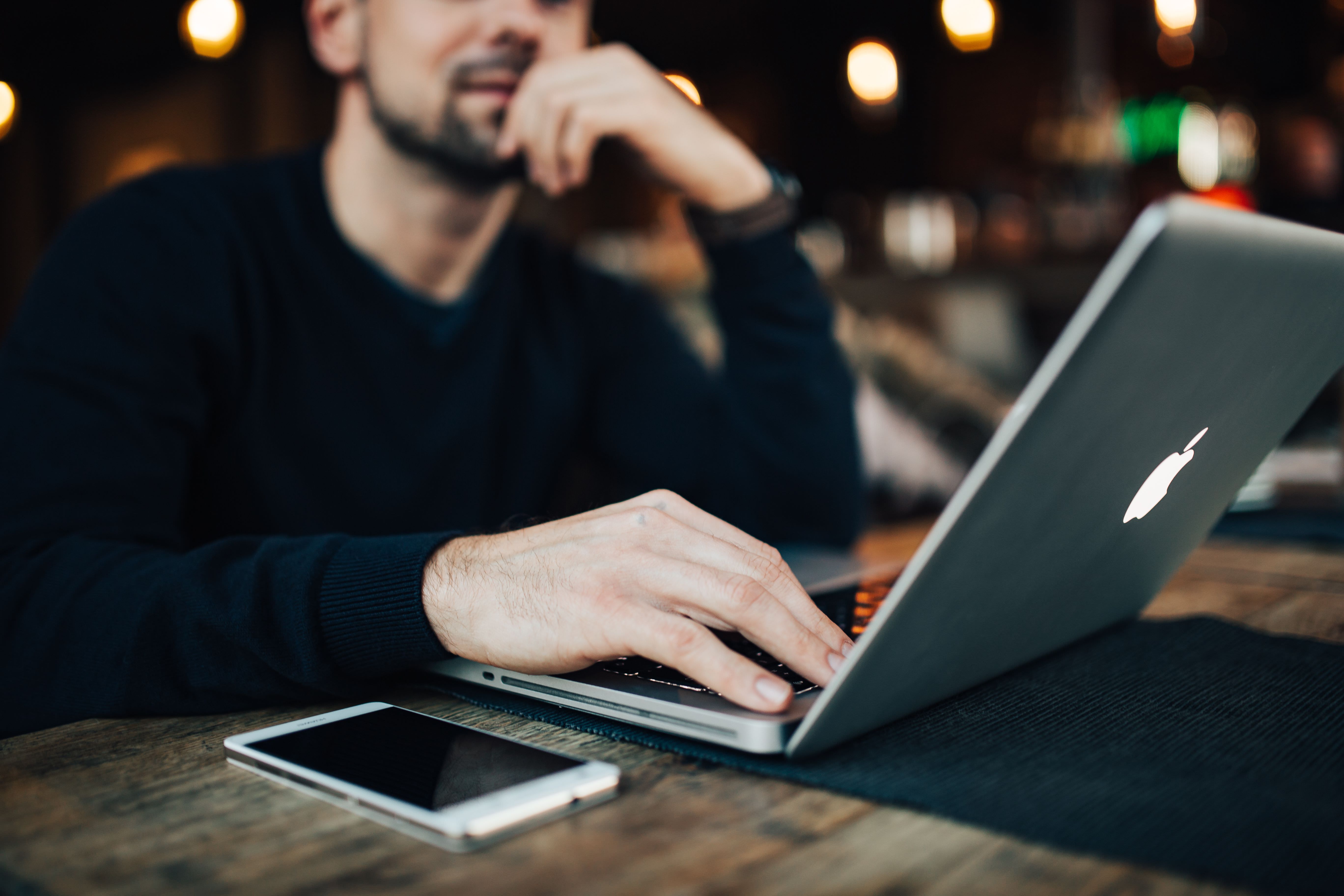 Designer works on laptop.