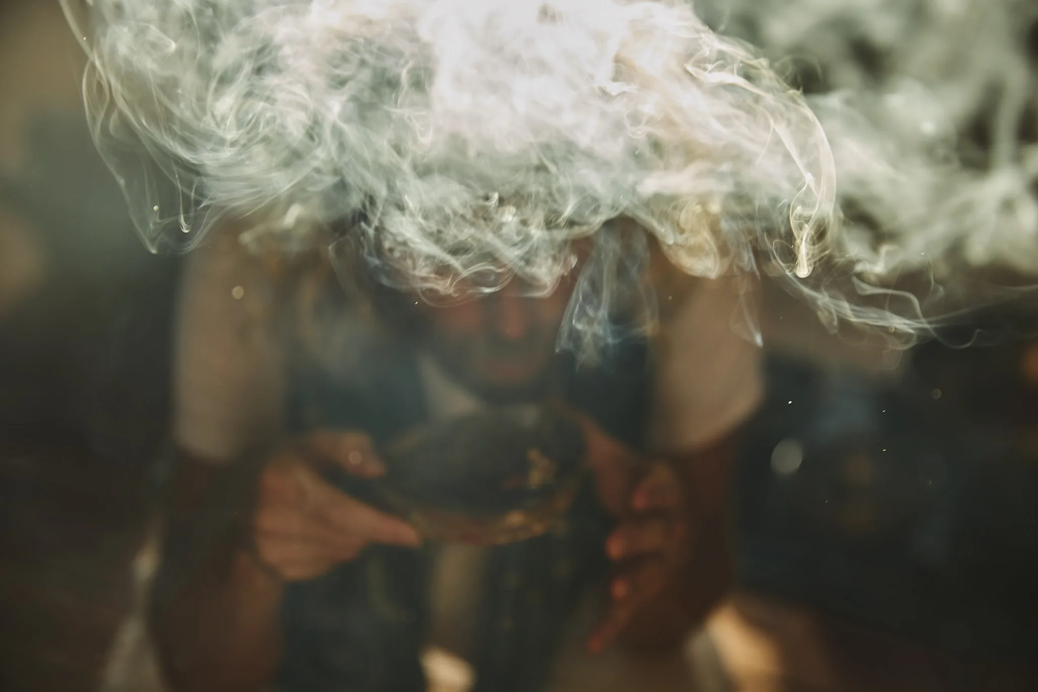 face vanishing behind exhaled smoke cloud — lifestyle photography by Tom Kubik