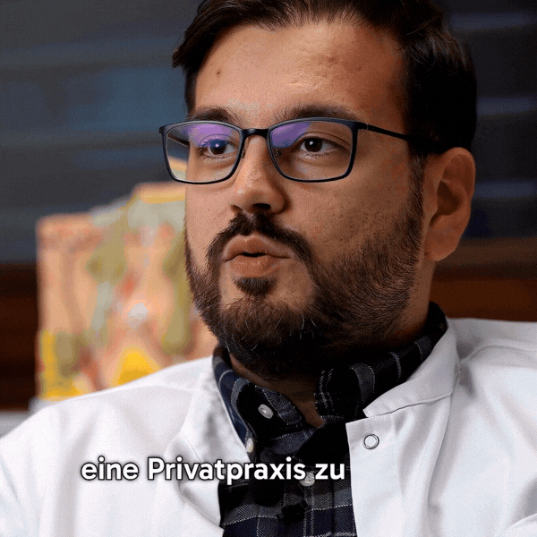 A stylish individual in a black shirt and silver pants stands against a blurred background, creating a dynamic and modern aesthetic.