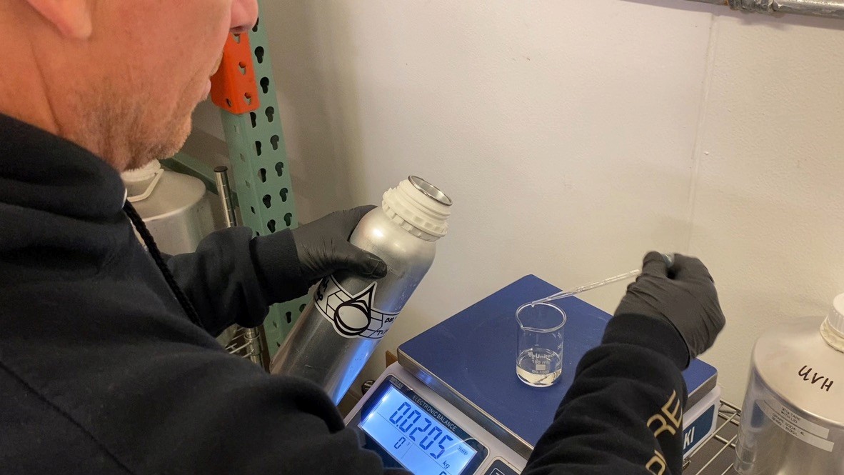 A man stading with Surfboard