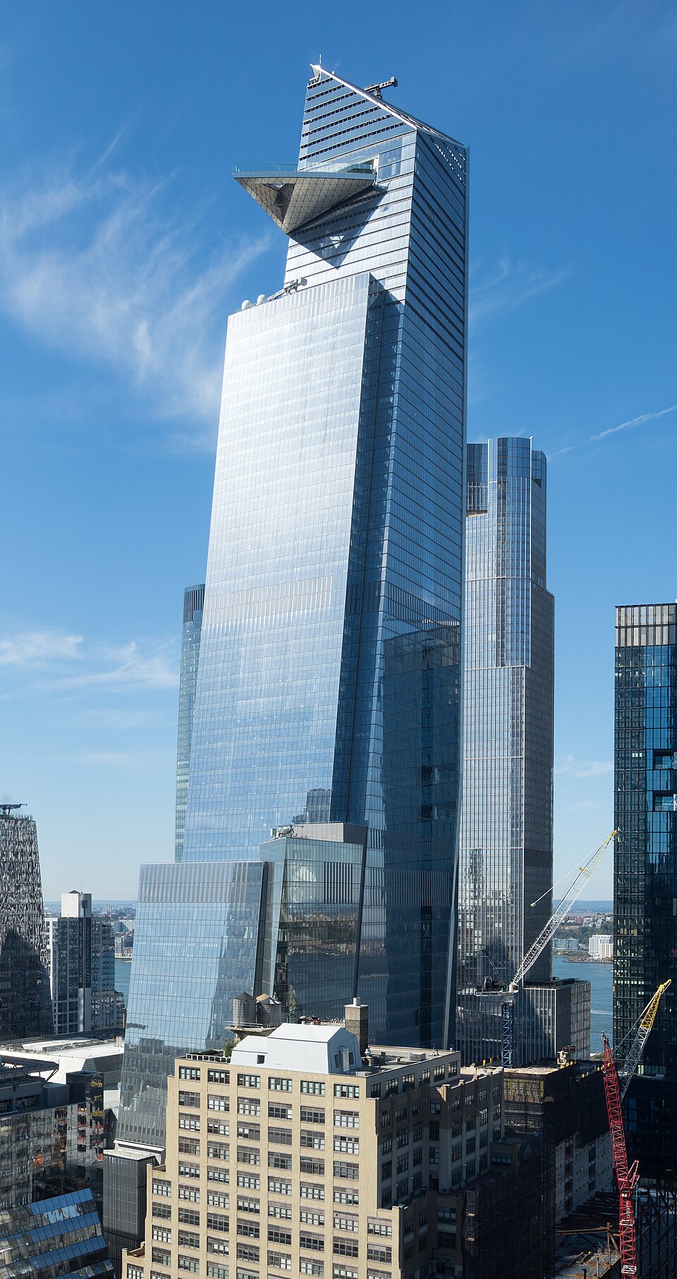 The 30 Hudson Yards skyscraper in NYC, featuring t eh Edge observation deck jutting out into the air near the top.