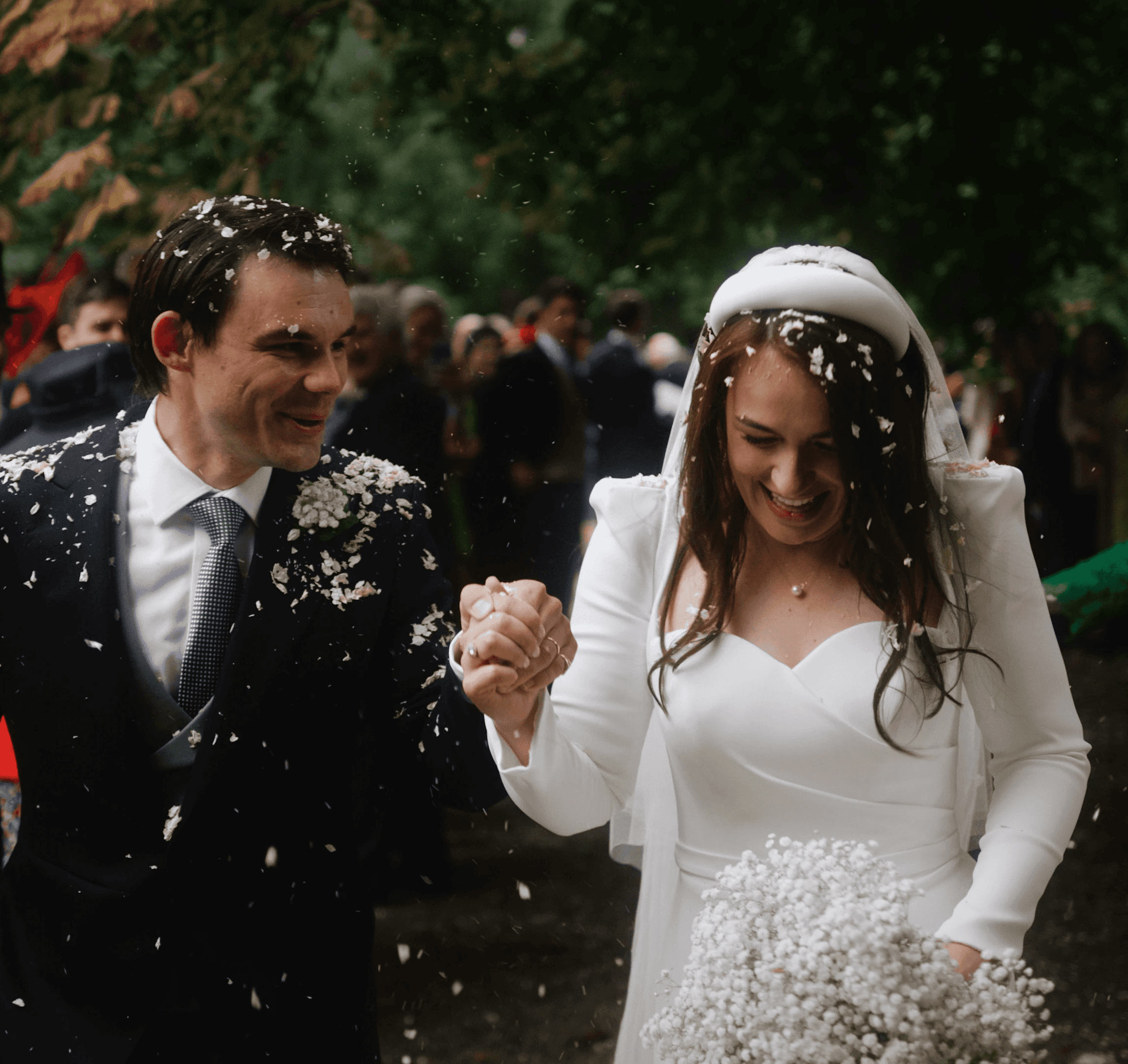 Bride and groom walking hand in hand through confetti during a private wedding celebration in Lincolnshire