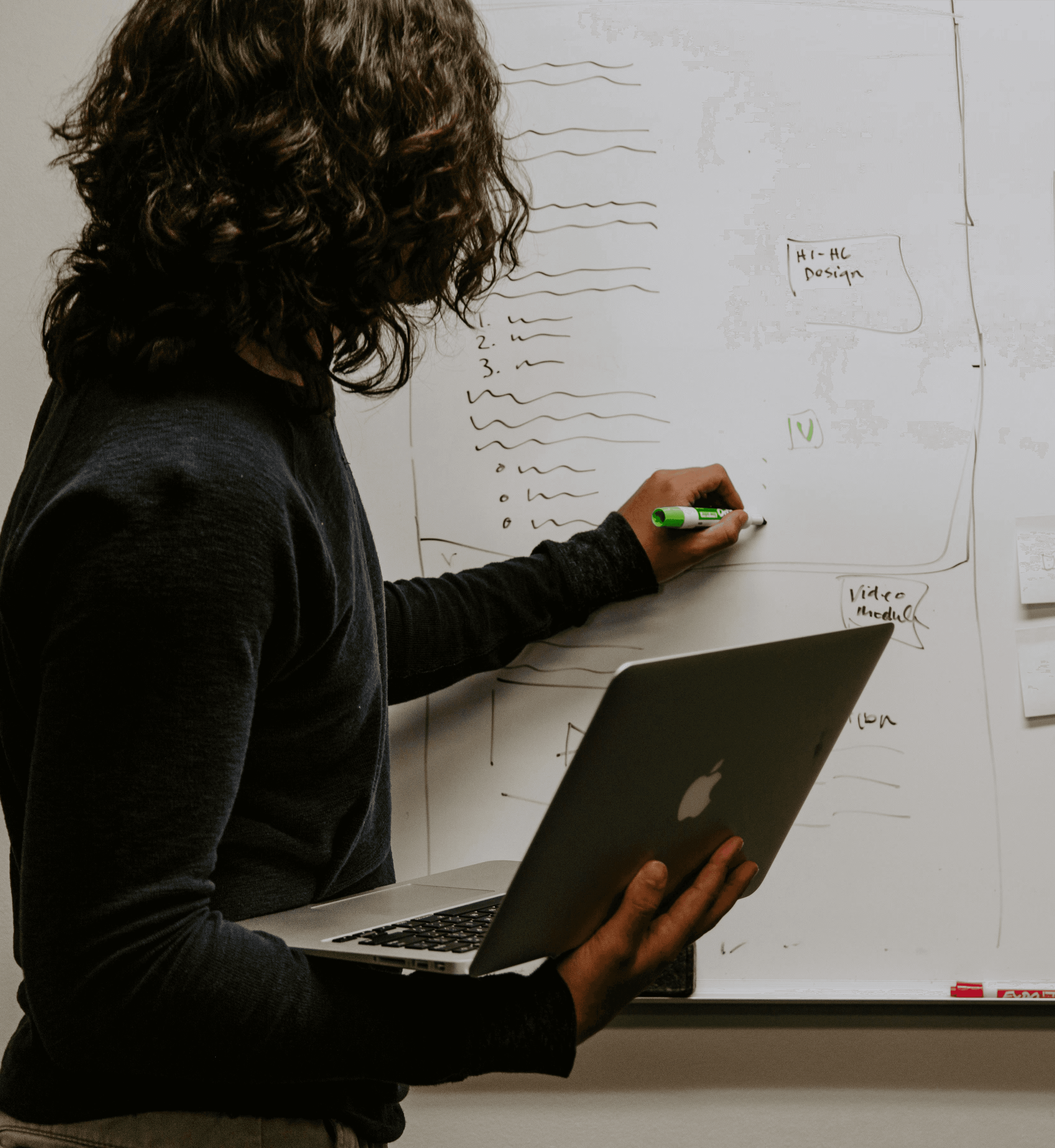 woman in green jacket standing near building during daytime