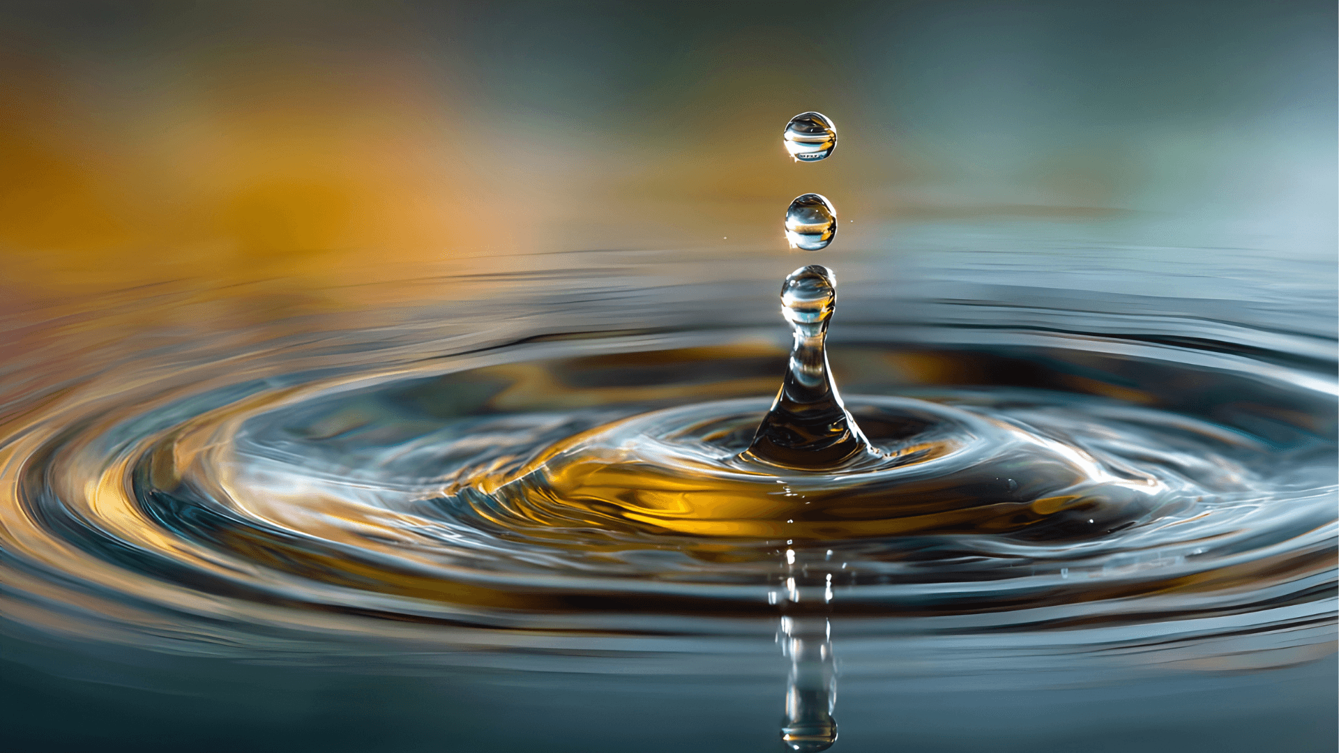 A winding road cuts through rocky terrain, surrounded by patches of green grass and illuminated by sunlight.