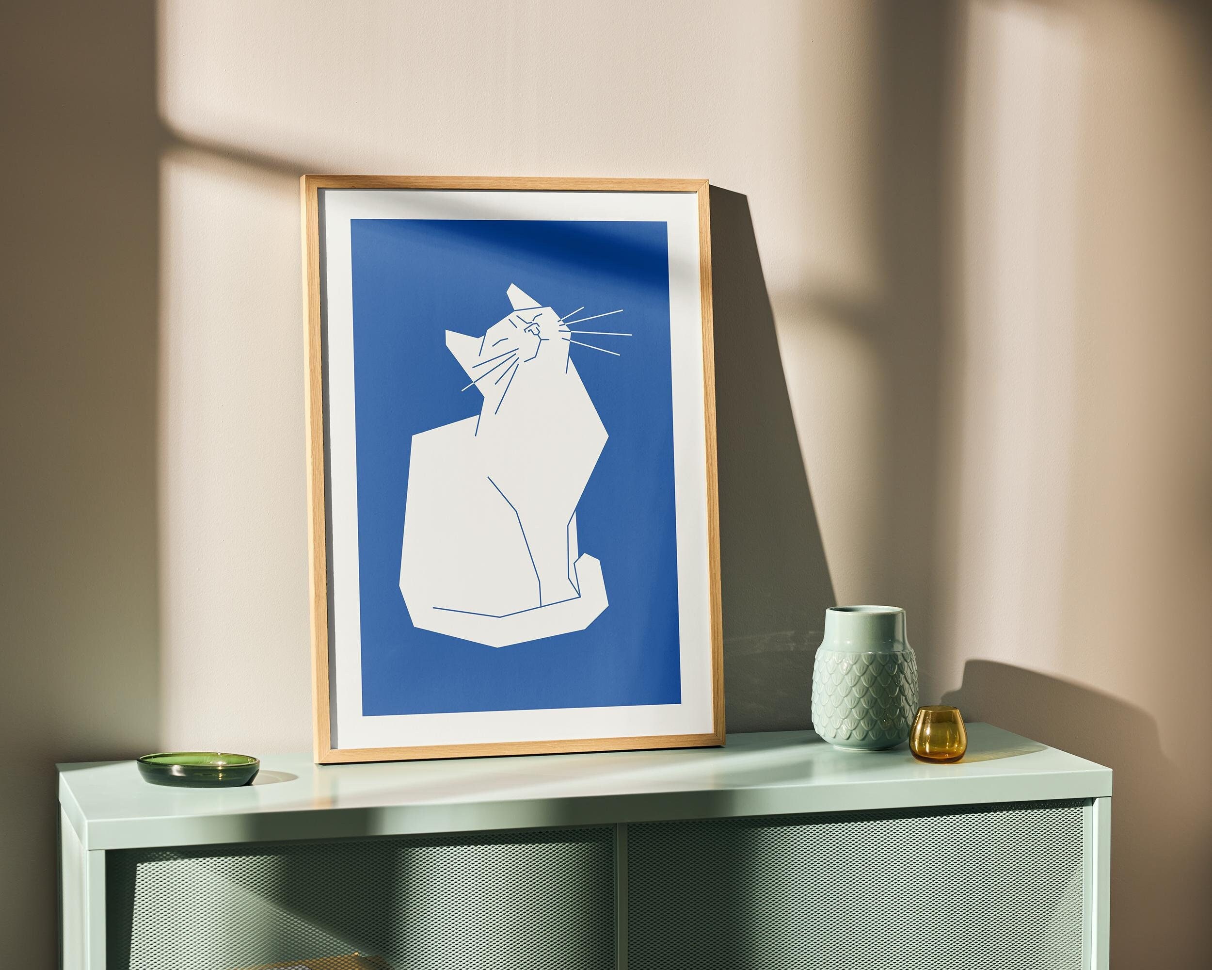 man wearing grey t-shirt standing in front of man sitting on chair