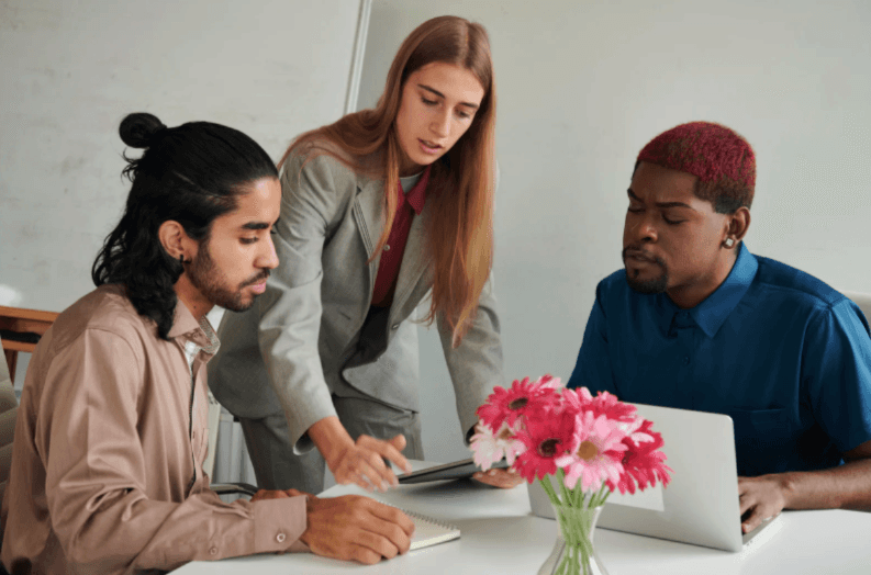 A wooden essential oil diffuser releasing a gentle stream of steam, surrounded by dried herbs and a small bottle of essential oil. The warm lighting enhances the cozy and therapeutic ambiance.