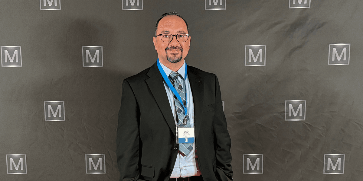 Zaid AlChalabi, founder of Far Out Solutions, stands confidently at an event, showcasing leadership in property management IT innovation.