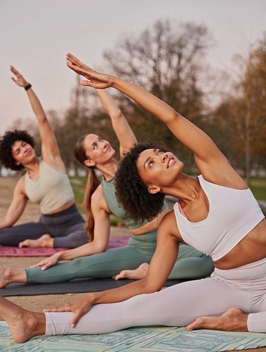 ladies practicing yoga on the mat