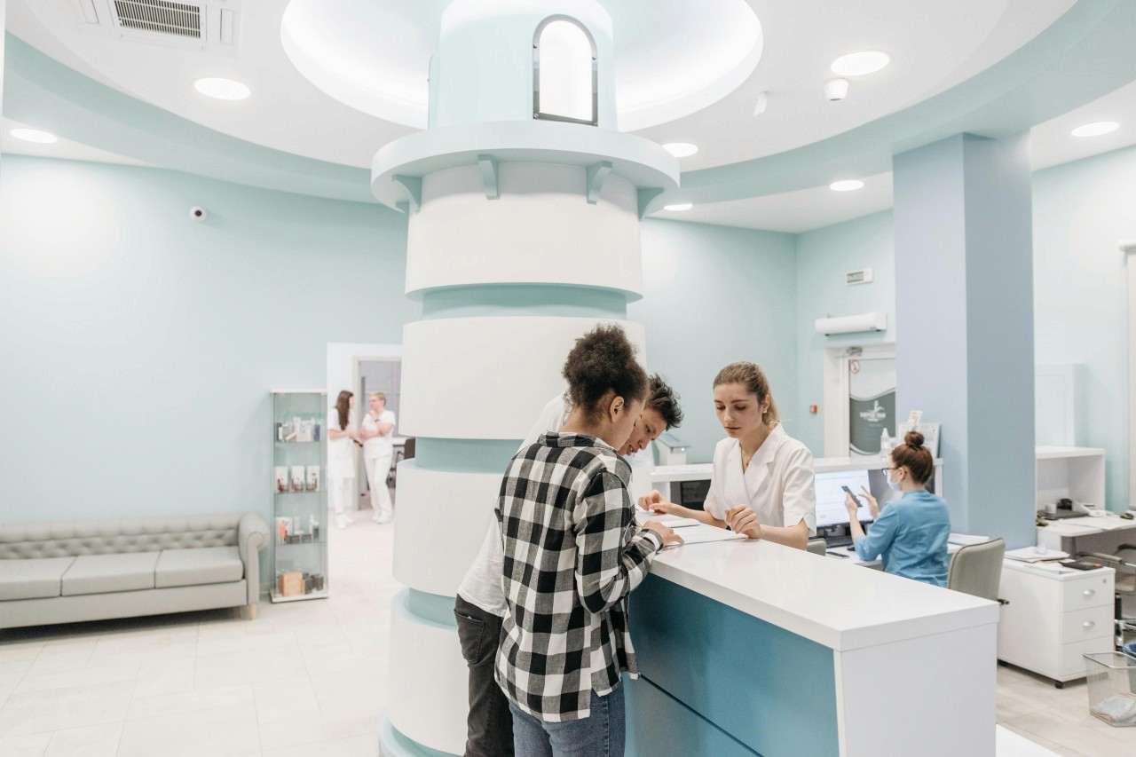 A couple is filling up a form in the dental clinic