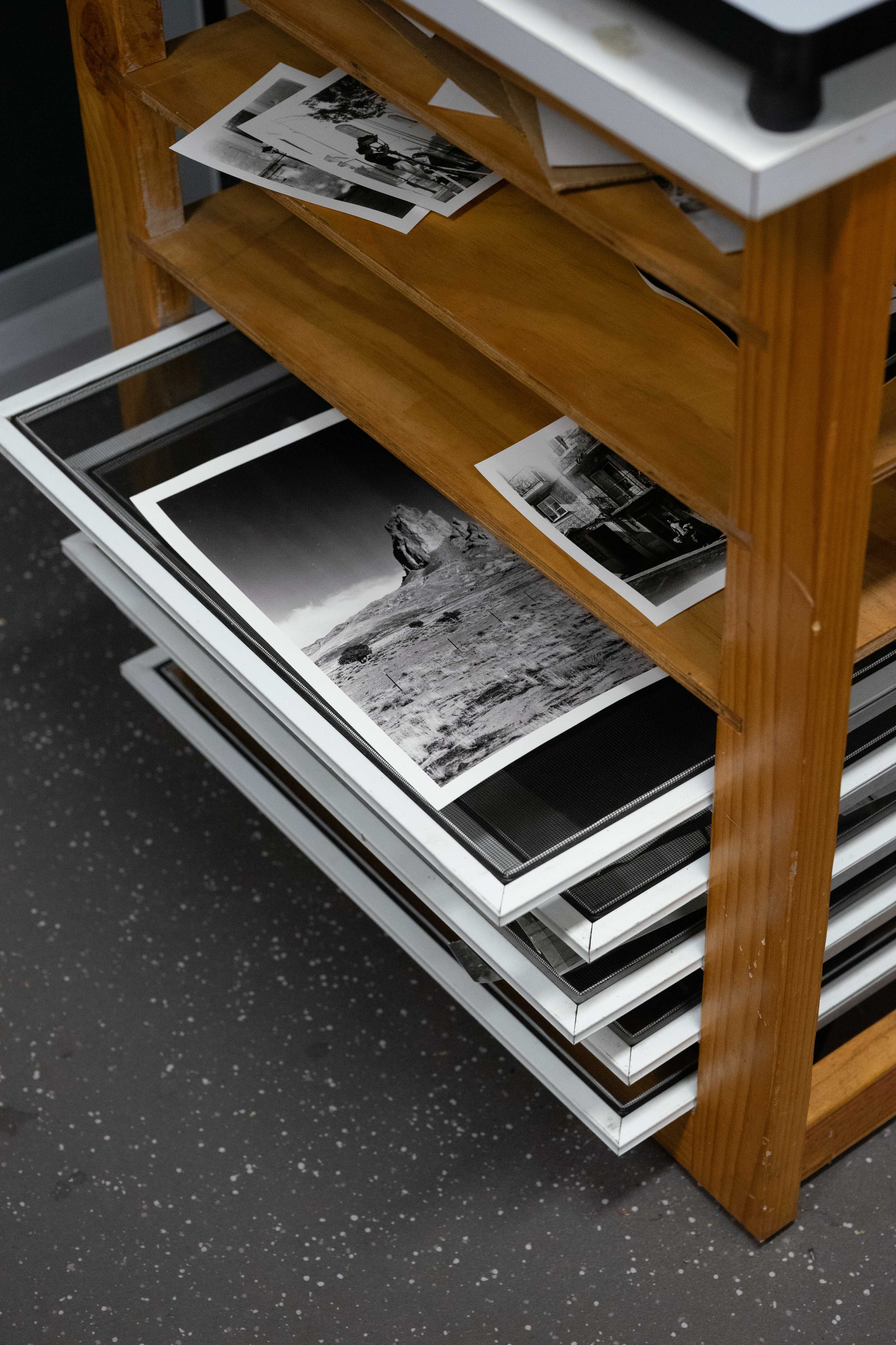 black and white darkroom prints on drying rack in brunswick darkroom