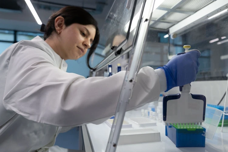 Scientist conducting experiments with advanced lab equipment