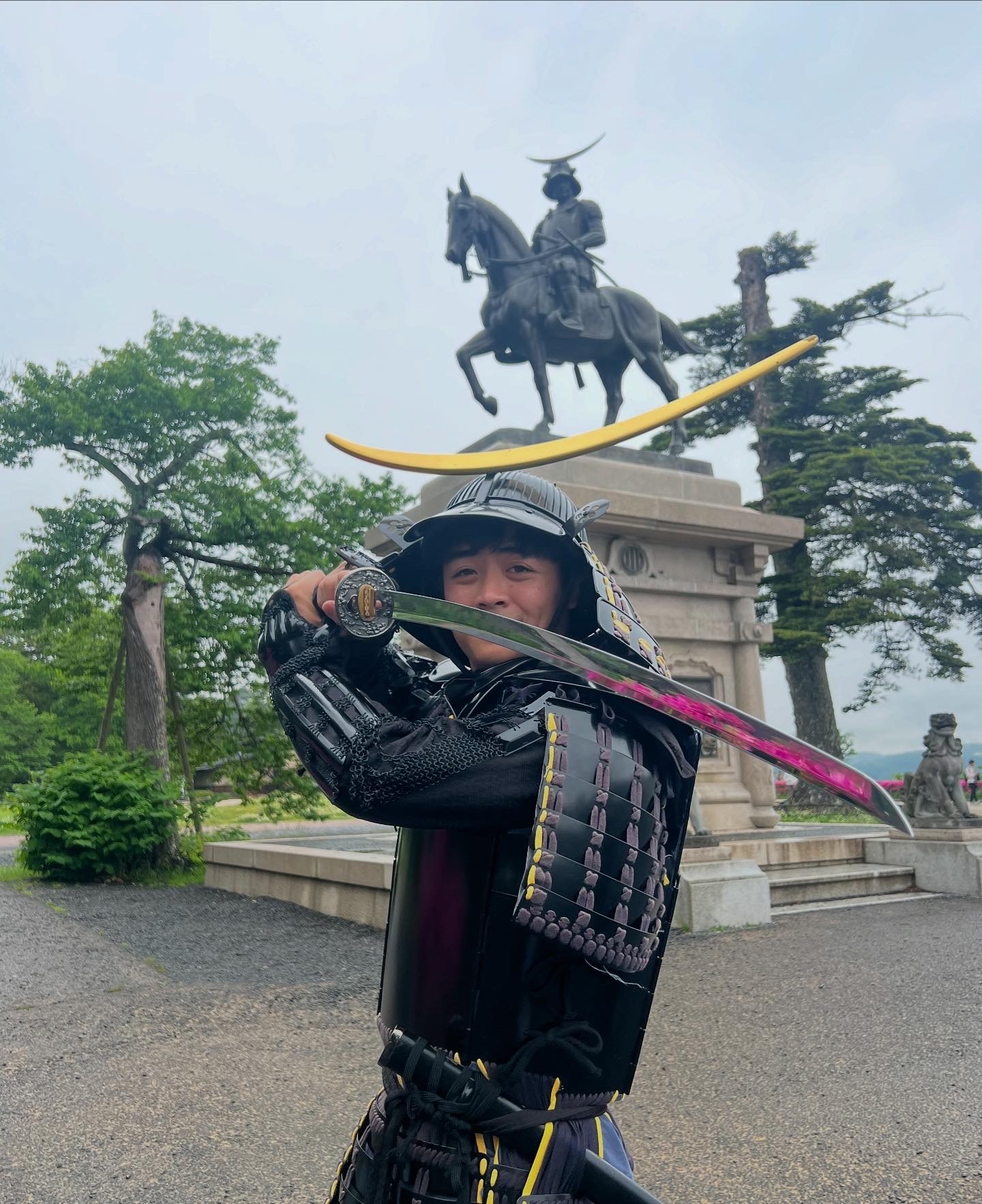 A close-up of a person wearing green-tinted glasses, with a serious expression and smooth skin.