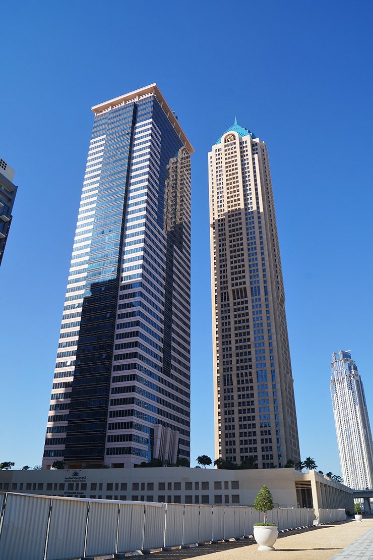 Modern skyscrapers under a clear blue sky, part of an exclusive portfolio of Business Bay real estate listings.