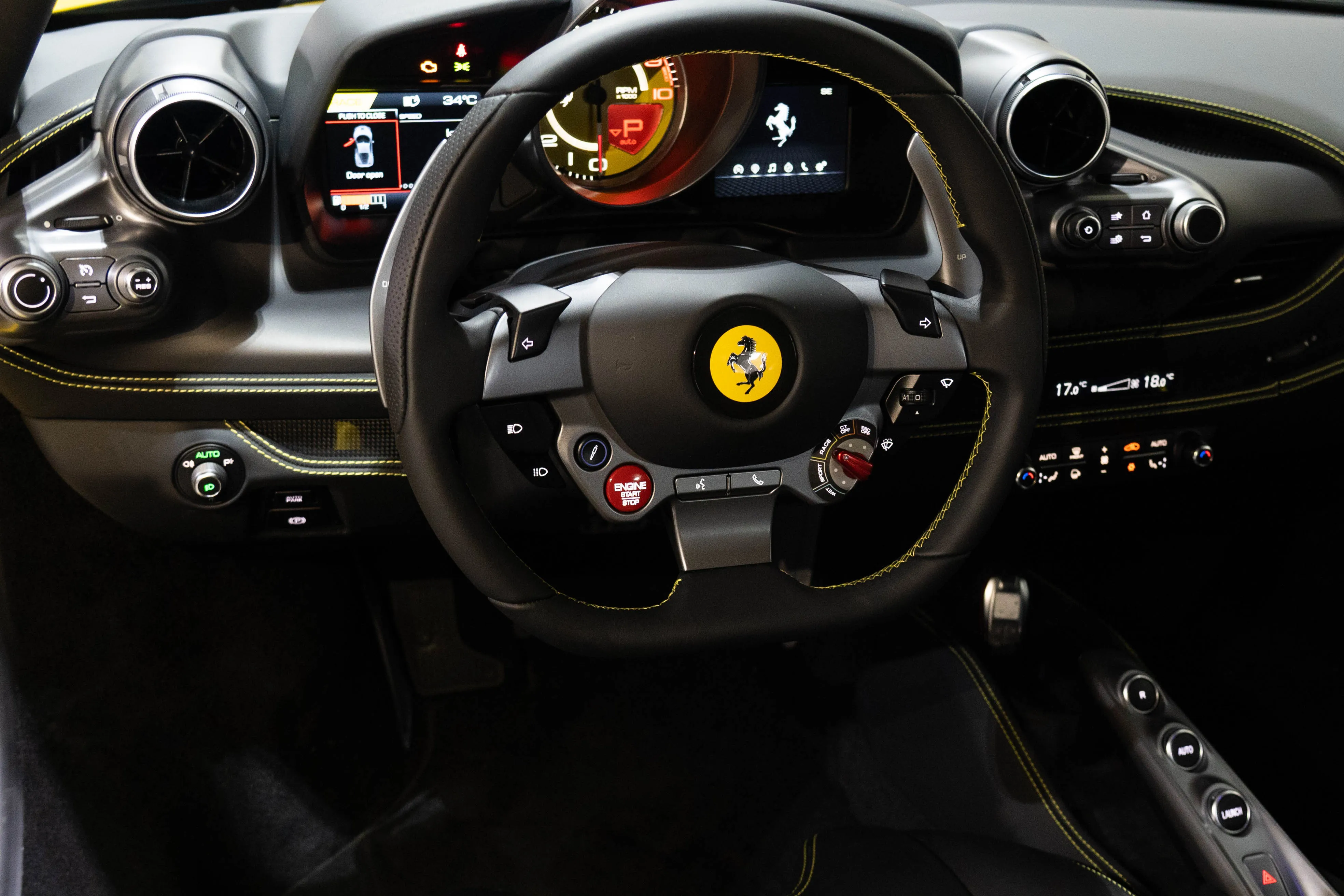 Ferrari F8 Tributo dashboard and interior view, featuring a digital driver display, carbon fiber details, and a driver-focused cockpit design.