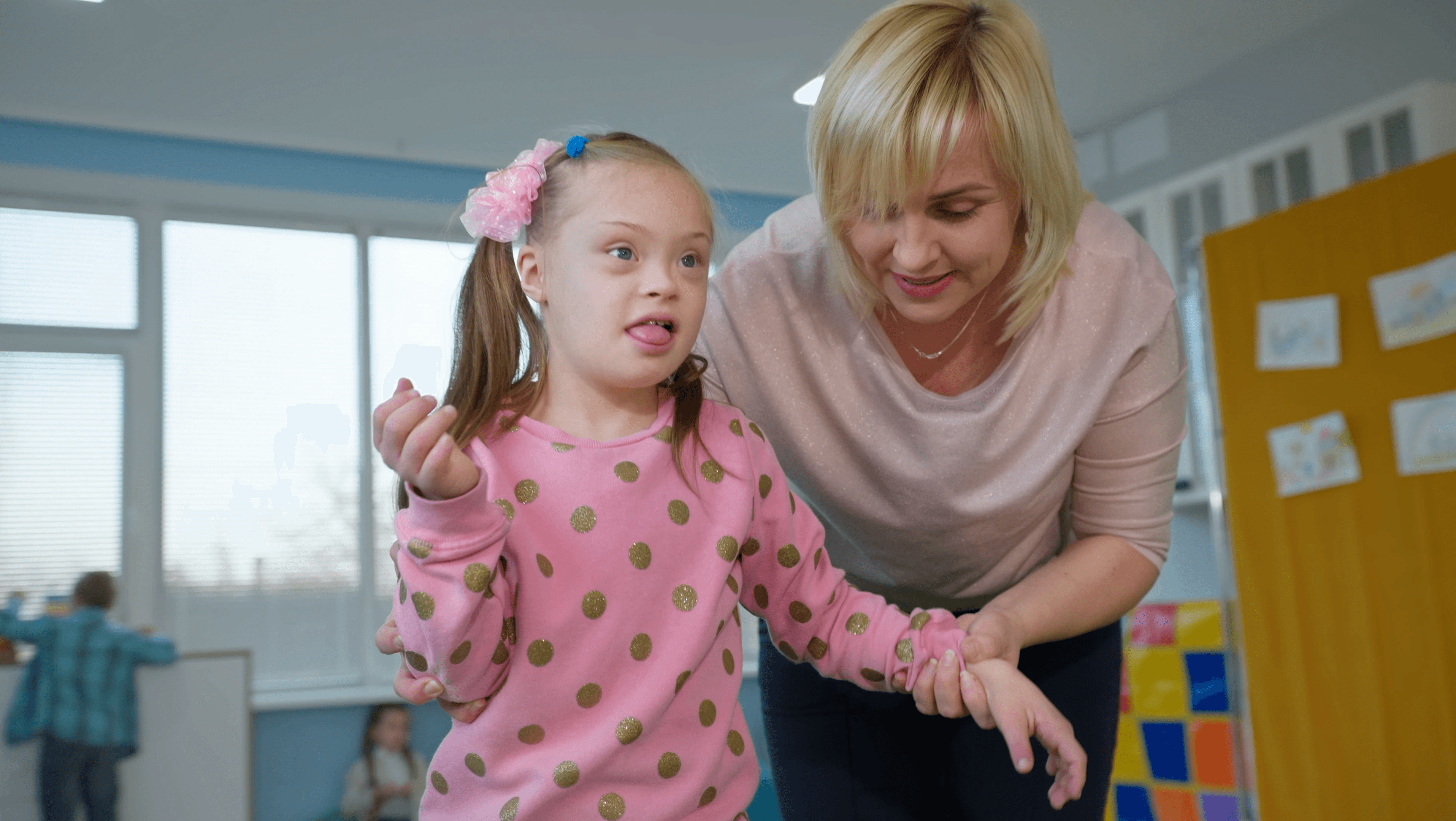 A women helping a young child.