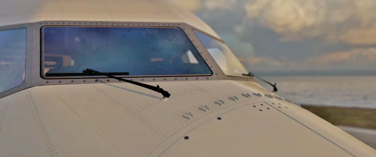 Head-on view of the AFL 737 MAX nose and windshield with wipers and rivet detail at sunset